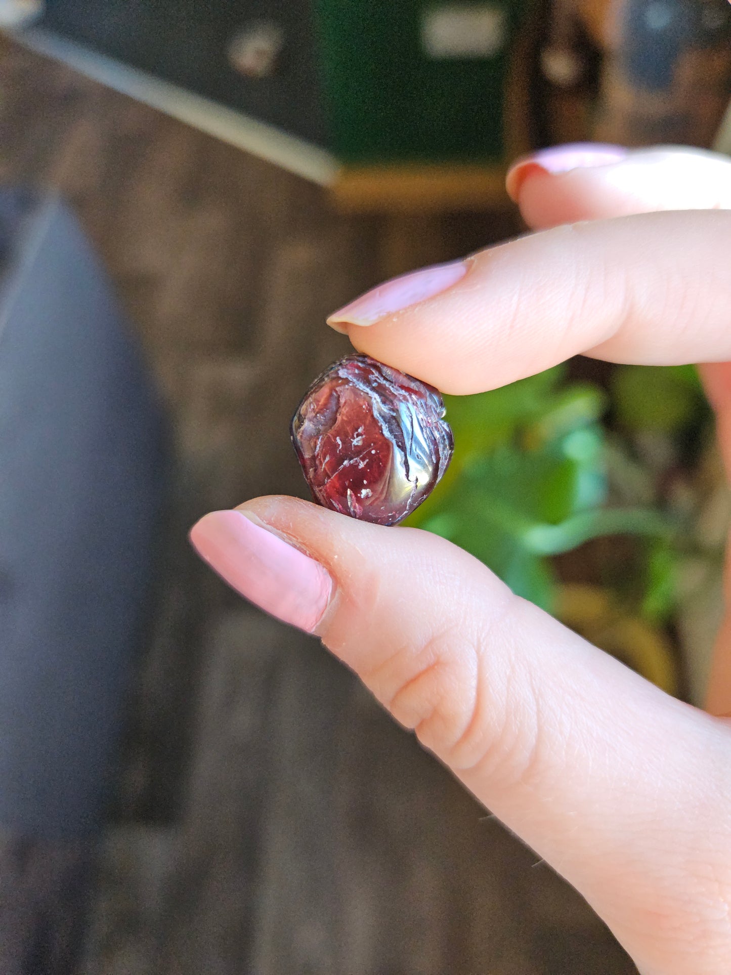 Garnet gemstone held up in hand