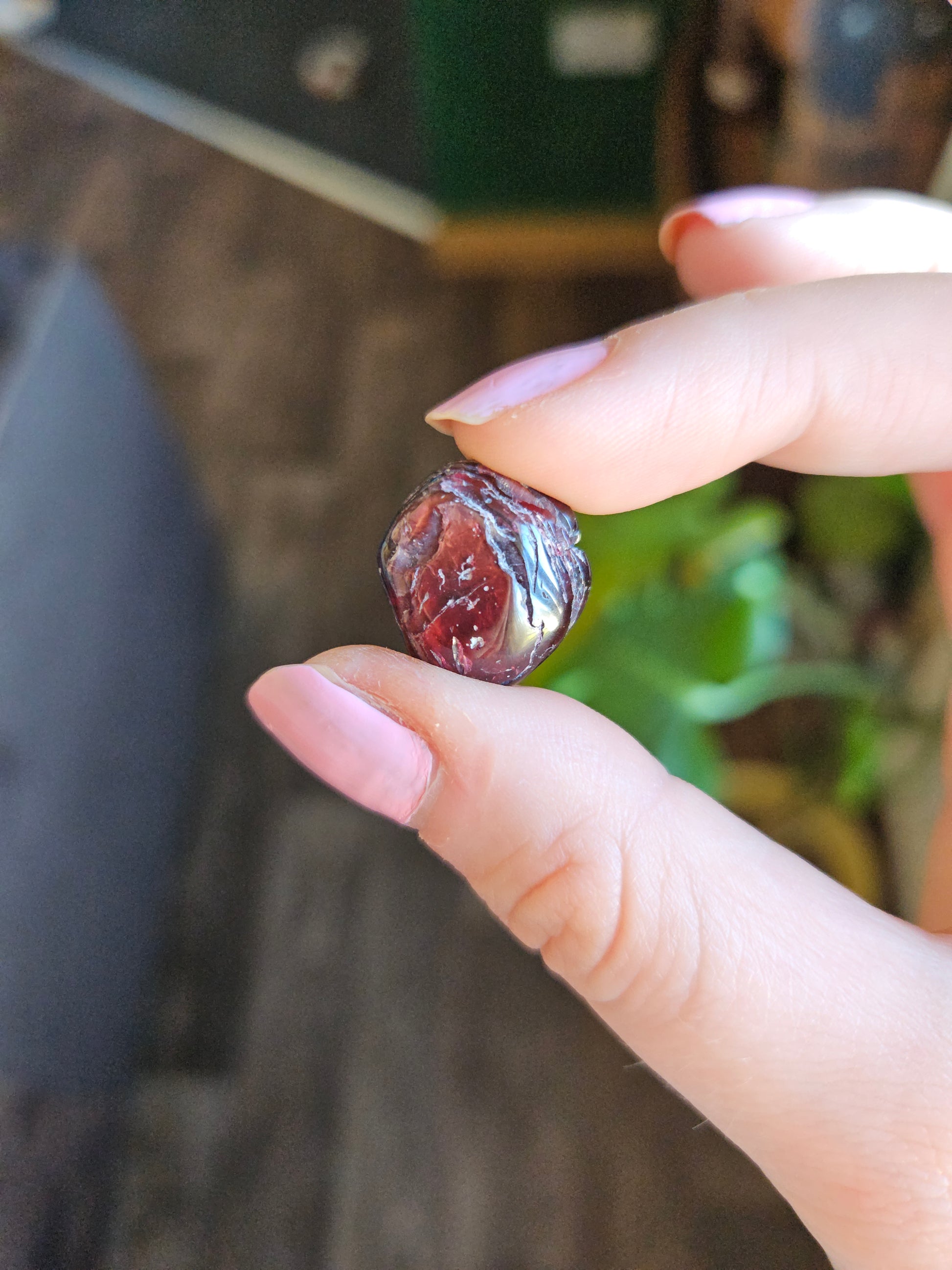 Garnet gemstone held up in hand